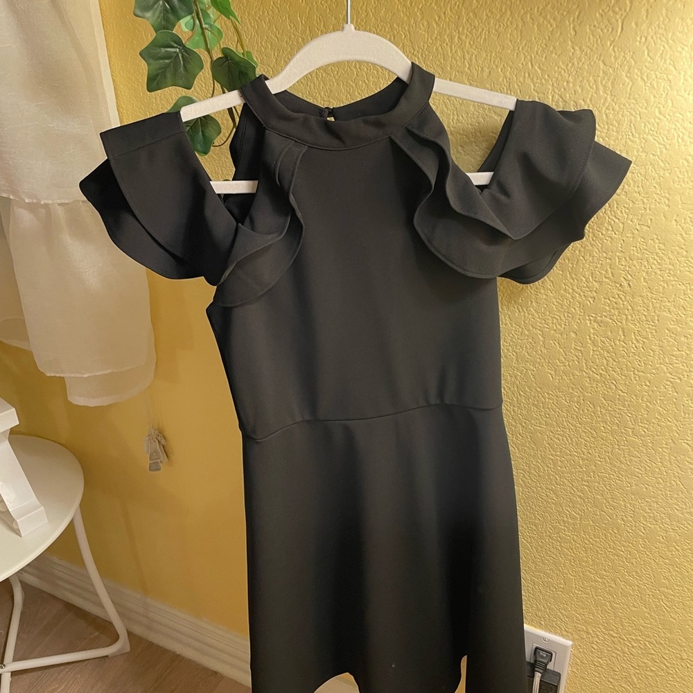 Black high-neck, off-shoulder dress.